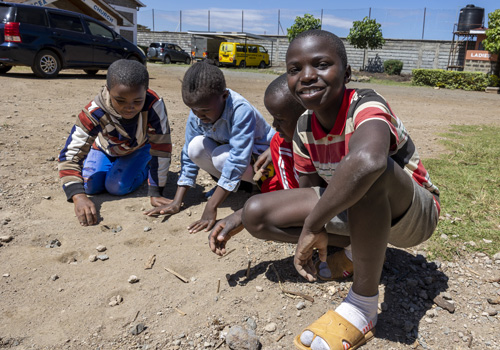 Keniaanse kinderen spelen het traditionele spel 'Kigogo'.